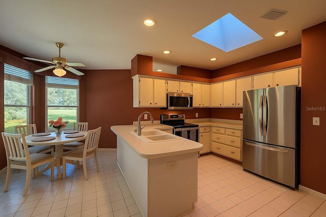 8926 SW 192nd Court Rd, Dunnellon, FL 34432 - kitchen featuring stainless steel appliances, a peninsula, light countertops, a sink, and a skylight