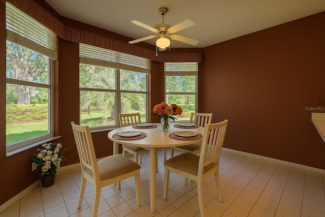 8926 SW 192nd Court Rd, Dunnellon, FL 34432 - dining room with plenty of natural light, a ceiling fan, baseboards, and light tile patterned floors
