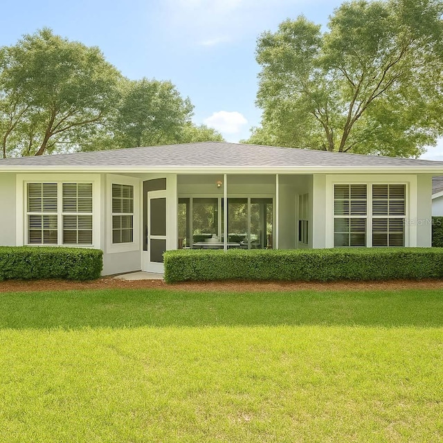 8926 SW 192nd Court Rd, Dunnellon, FL 34432 - back of house featuring a lawn and stucco siding