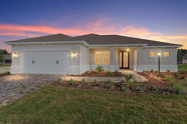 10569 SW 98th Pl, Ocala, FL 34481 - ranch-style house featuring stucco siding, an attached garage, decorative driveway, and a front lawn
