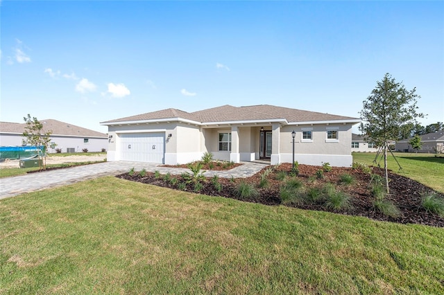 10569 SW 98th Pl, Ocala, FL 34481 - ranch-style home with stucco siding, an attached garage, decorative driveway, and a front yard