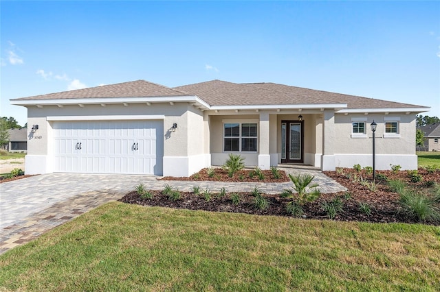10569 SW 98th Pl, Ocala, FL 34481 - ranch-style home with stucco siding, a garage, a front yard, decorative driveway, and a shingled roof