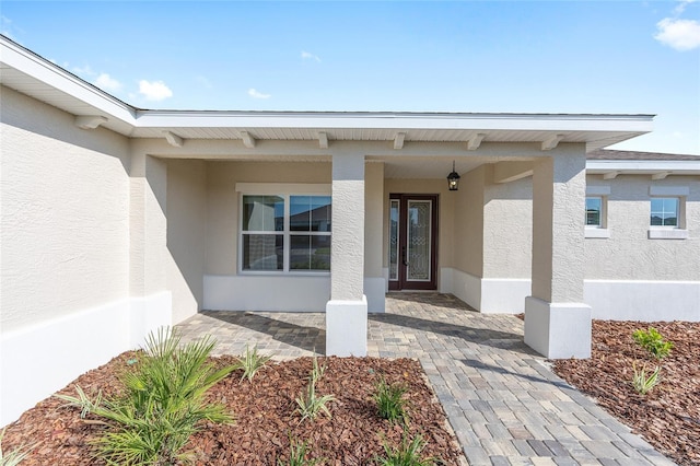10569 SW 98th Pl, Ocala, FL 34481 - view of exterior entry with stucco siding and a porch