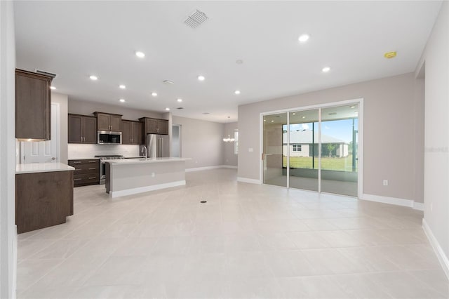 10569 SW 98th Pl, Ocala, FL 34481 - unfurnished living room featuring baseboards, recessed lighting, a sink, and light tile patterned flooring