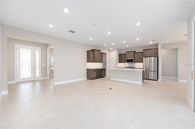 10569 SW 98th Pl, Ocala, FL 34481 - unfurnished living room with baseboards, a sink, recessed lighting, and light tile patterned floors