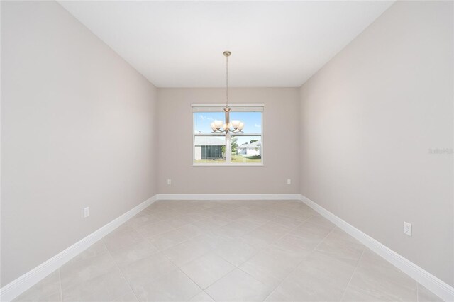 10569 SW 98th Pl, Ocala, FL 34481 - unfurnished room with a chandelier, light tile patterned flooring, and baseboards