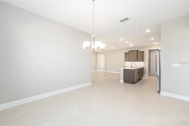 10569 SW 98th Pl, Ocala, FL 34481 - kitchen with open floor plan, freestanding refrigerator, a chandelier, light countertops, and a sink