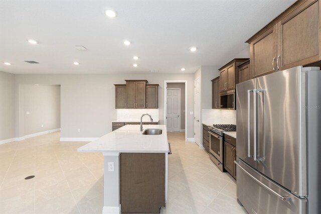 10569 SW 98th Pl, Ocala, FL 34481 - kitchen featuring premium appliances, backsplash, light countertops, a kitchen island with sink, and recessed lighting