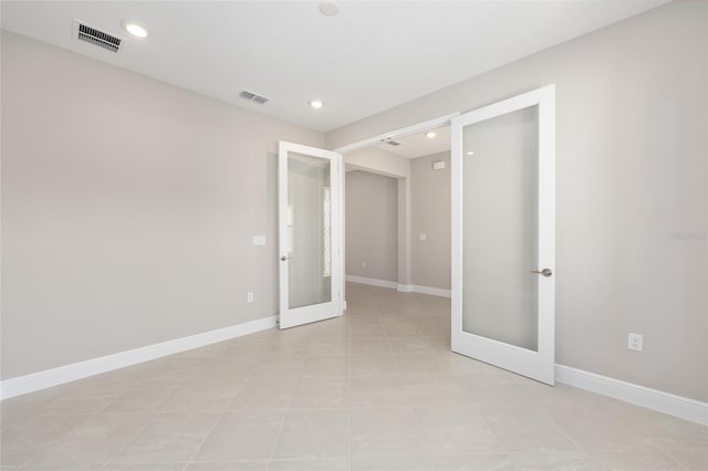 10569 SW 98th Pl, Ocala, FL 34481 - unfurnished bedroom with french doors, baseboards, recessed lighting, and light tile patterned flooring