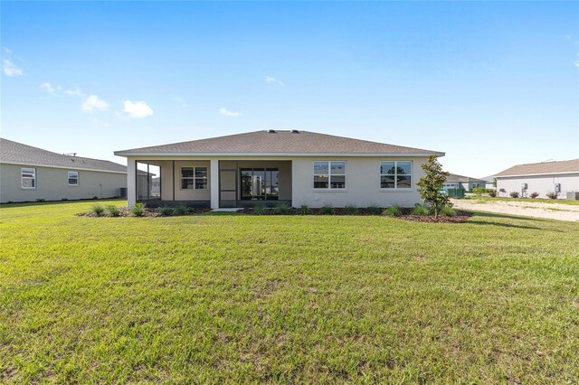 10569 SW 98th Pl, Ocala, FL 34481 - back of house featuring a yard and stucco siding