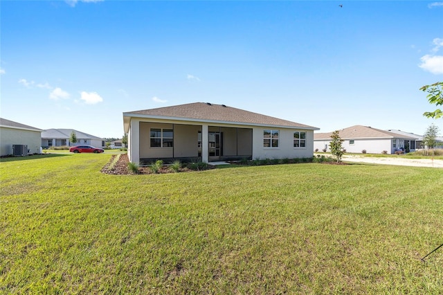 10569 SW 98th Pl, Ocala, FL 34481 - view of front of house with central air condition unit, a front lawn, and stucco siding