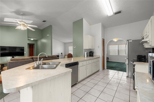 2521 NW 45th Pl, Ocala, FL 34475 - kitchen featuring dishwasher, a sink, light countertops, a peninsula, and lofted ceiling