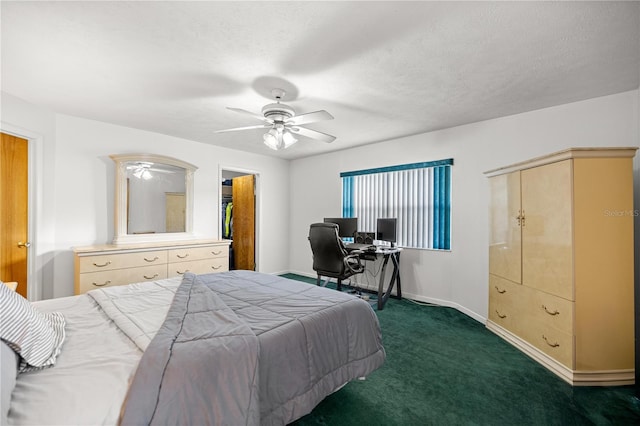 2521 NW 45th Pl, Ocala, FL 34475 - bedroom with dark colored carpet, baseboards, a desk, ceiling fan, and a spacious closet