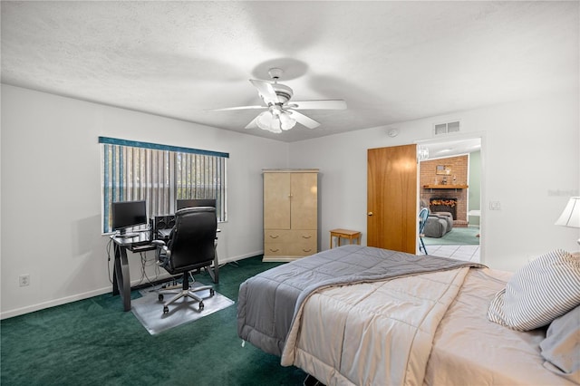 2521 NW 45th Pl, Ocala, FL 34475 - bedroom with a desk, carpet flooring, baseboards, a fireplace, and a ceiling fan