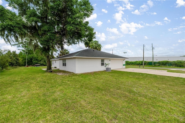 2521 NW 45th Pl, Ocala, FL 34475 - view of home's exterior featuring driveway, an attached garage, a yard, and central air condition unit