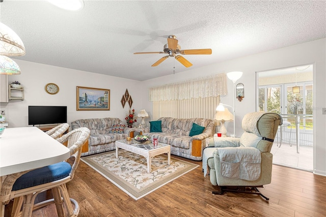 8710 SW 91st St Unit E, Ocala, FL 34481 - living room with a textured ceiling, a ceiling fan, and wood finished floors