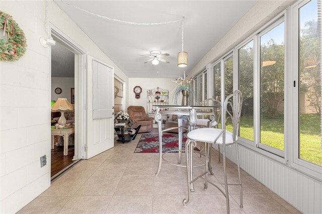 8710 SW 91st St Unit E, Ocala, FL 34481 - sunroom featuring ceiling fan and tile patterned flooring