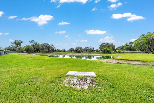 surrounding community featuring a water view and a yard