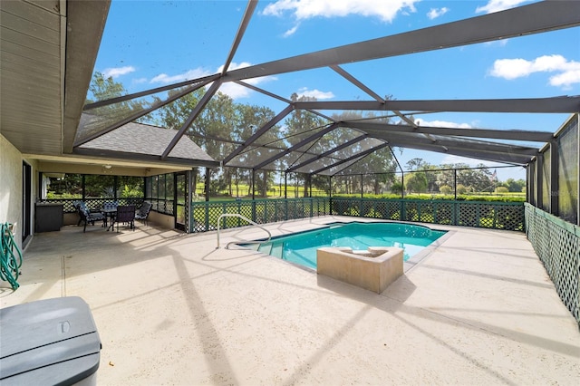 view of pool featuring a patio and glass enclosure