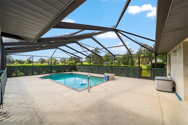 view of pool with a patio area and a lanai