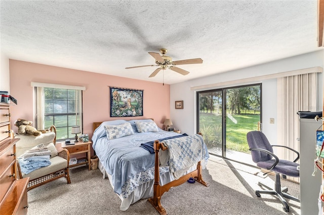 carpeted bedroom featuring access to outside, ceiling fan, and a textured ceiling