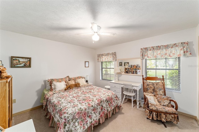 bedroom featuring light colored carpet, baseboards, and ceiling fan