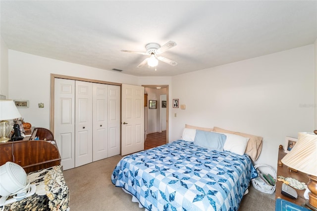 carpeted bedroom with a closet and a ceiling fan