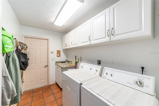 clothes washing area with washer and dryer, cabinet space, and tile patterned floors
