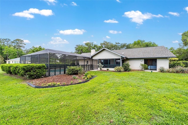 back of house featuring stucco siding, a lawn, and a chimney