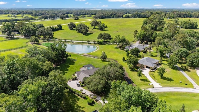 aerial overview of property's location featuring a tree filled landscape