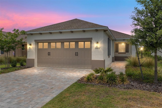 10427 SW 98th Place Rd, Ocala, FL 34481 - view of front of property featuring stucco siding, an attached garage, decorative driveway, and roof with shingles