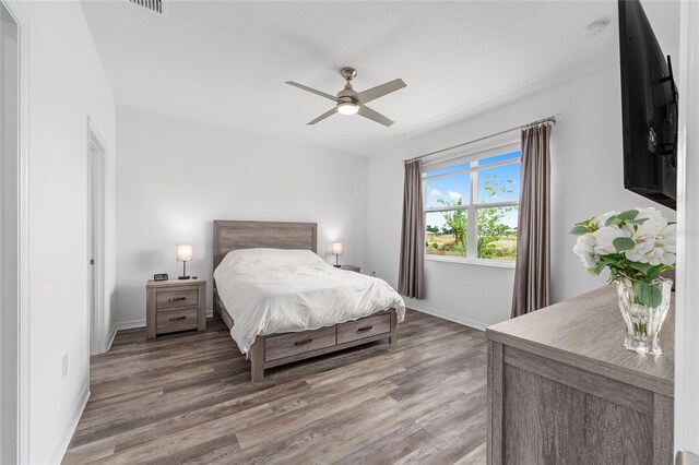 10427 SW 98th Place Rd, Ocala, FL 34481 - bedroom with baseboards, light wood-type flooring, and ceiling fan