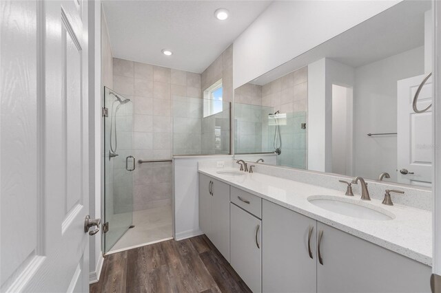 10427 SW 98th Place Rd, Ocala, FL 34481 - bathroom featuring a stall shower, wood finished floors, double vanity, and recessed lighting