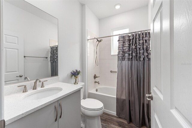 10427 SW 98th Place Rd, Ocala, FL 34481 - bathroom with wood finished floors, vanity, toilet, and shower / bathtub combination with curtain
