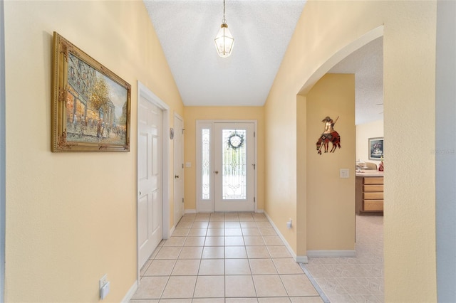 2608 Casso Ct, The Villages, FL 32162 - entrance foyer with arched walkways, light tile patterned flooring, and baseboards