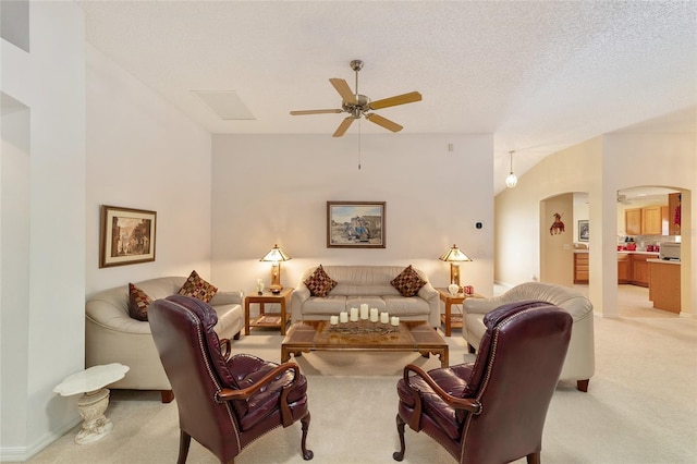 2608 Casso Ct, The Villages, FL 32162 - living area featuring arched walkways, light colored carpet, and a ceiling fan