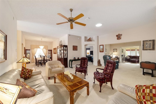 2608 Casso Ct, The Villages, FL 32162 - living area featuring light carpet, a ceiling fan, and a chandelier