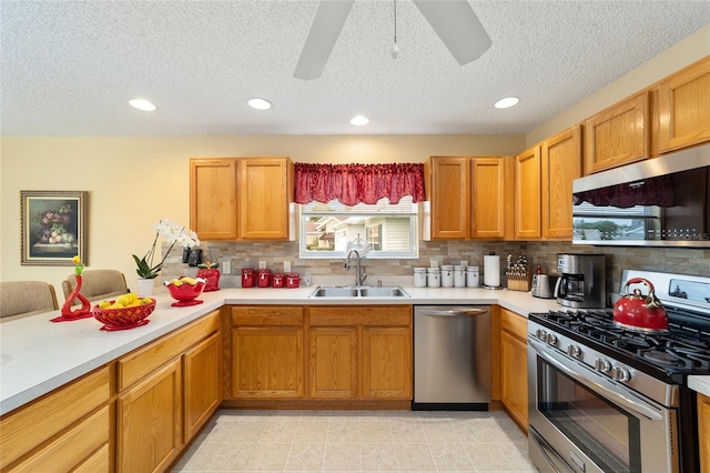2608 Casso Ct, The Villages, FL 32162 - kitchen with stainless steel appliances, a sink, a textured ceiling, decorative backsplash, and light countertops