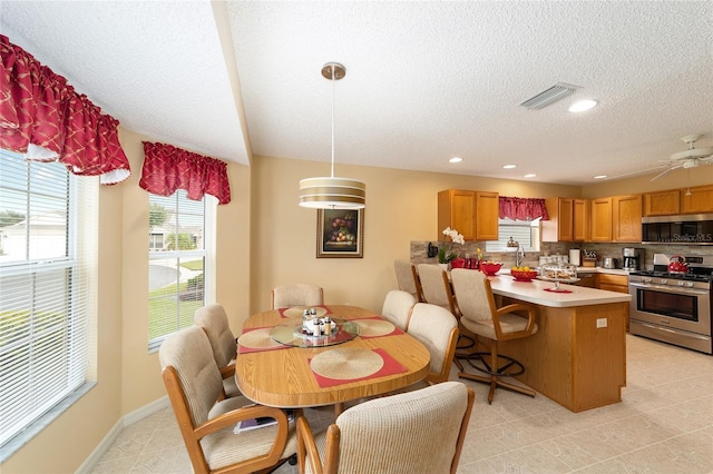 2608 Casso Ct, The Villages, FL 32162 - dining space featuring a textured ceiling and recessed lighting
