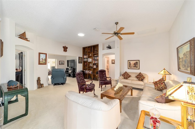 2608 Casso Ct, The Villages, FL 32162 - living area featuring arched walkways, carpet, a ceiling fan, recessed lighting, and a textured ceiling