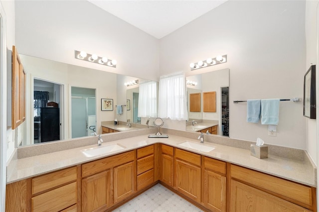2608 Casso Ct, The Villages, FL 32162 - full bathroom with double vanity, a stall shower, tile patterned floors, and a walk in closet