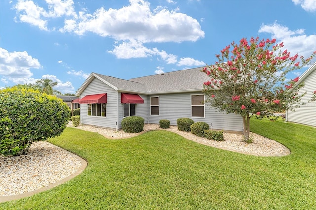 2608 Casso Ct, The Villages, FL 32162 - back of house with a lawn and roof with shingles