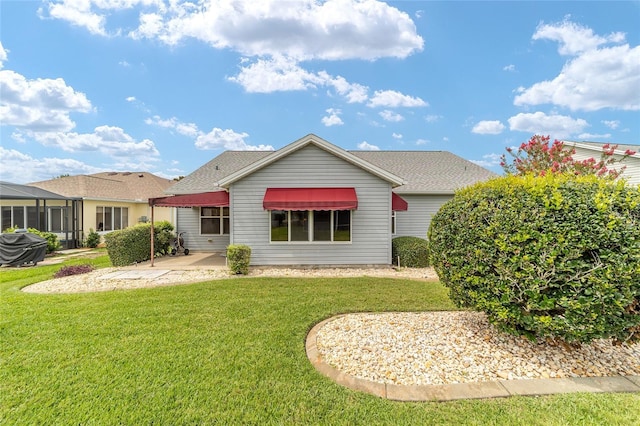 2608 Casso Ct, The Villages, FL 32162 - view of front of home with a front lawn, a patio, and a shingled roof