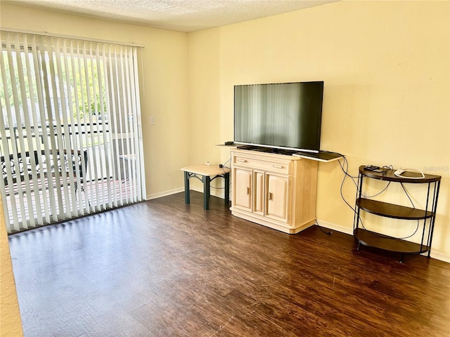 3705 SW 27th St Unit 621, Gainesville, FL 32608 - living room featuring dark wood-style flooring, baseboards, and a textured ceiling