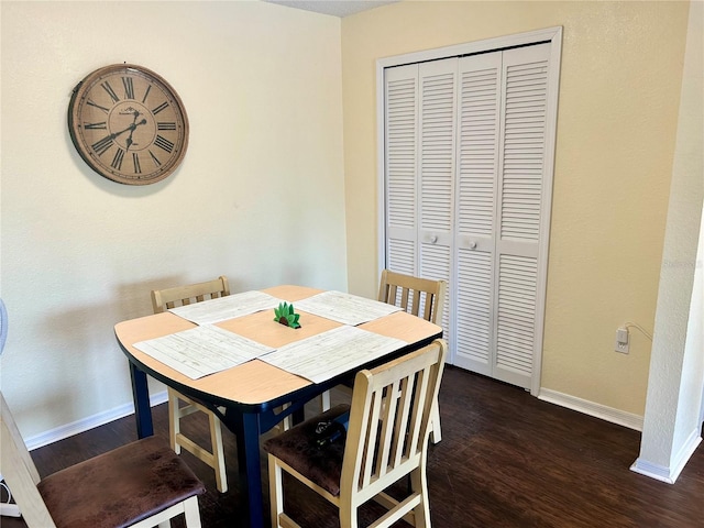 3705 SW 27th St Unit 621, Gainesville, FL 32608 - dining area with dark wood-style flooring and baseboards