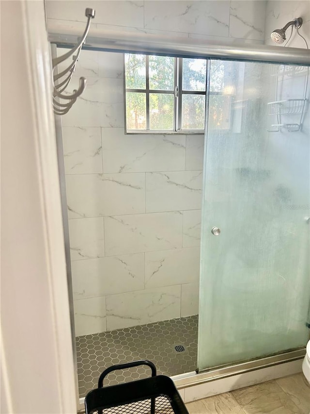 3705 SW 27th St Unit 621, Gainesville, FL 32608 - full bathroom with a shower stall, marble look tile flooring, and toilet