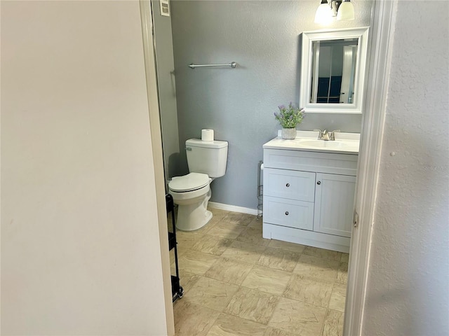 3705 SW 27th St Unit 621, Gainesville, FL 32608 - bathroom featuring toilet, vanity, and baseboards
