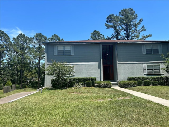 2715 NW 104th Ct Unit 1, Gainesville, FL 32606 - view of front of house with a front yard and stucco siding