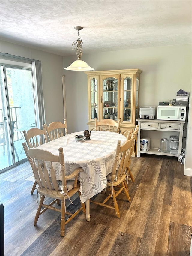 2715 NW 104th Ct Unit 1, Gainesville, FL 32606 - dining area featuring dark wood-type flooring
