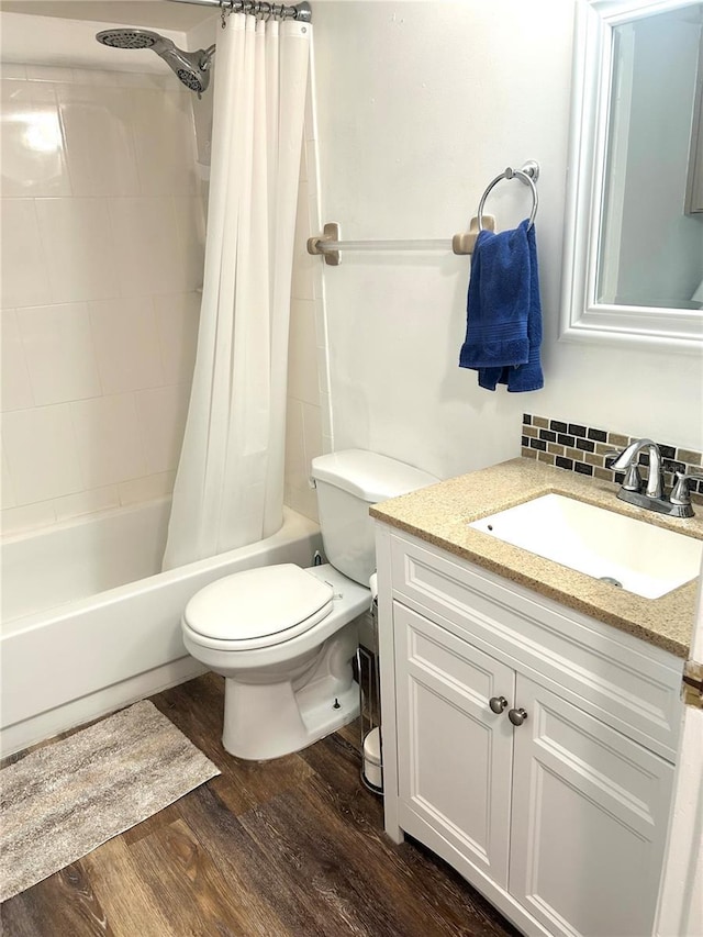2715 NW 104th Ct Unit 1, Gainesville, FL 32606 - full bathroom featuring toilet, vanity, wood finished floors, and shower / bath combo with shower curtain